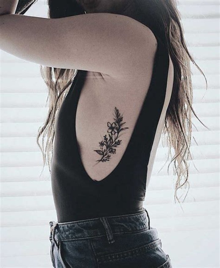 Floral rib tattoo Small Rib Tattoos, Flower Tattoo On Ribs, Side
