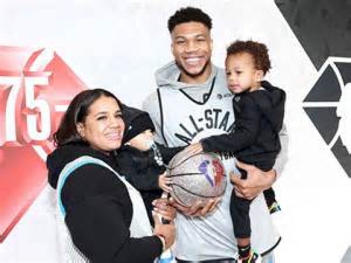 Giannis and Liam Charles Antetokounmpo poses with son on his lap